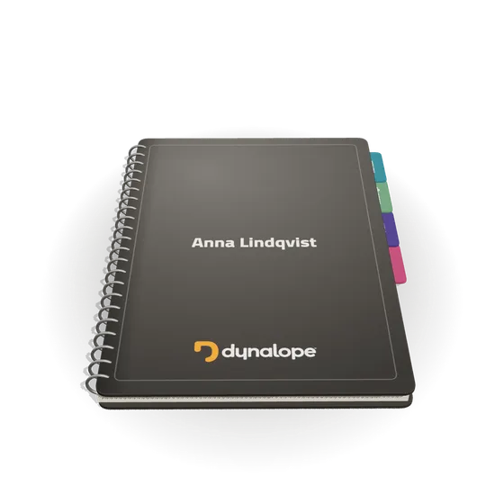 The Dynabook: a dark A4 notebook with wire binding, coloured tabs and the Dynalope mark on the cover.